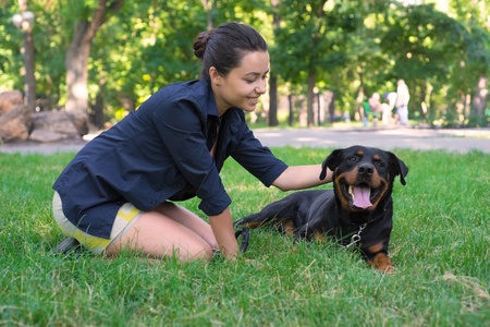 woman petting her rottweiler